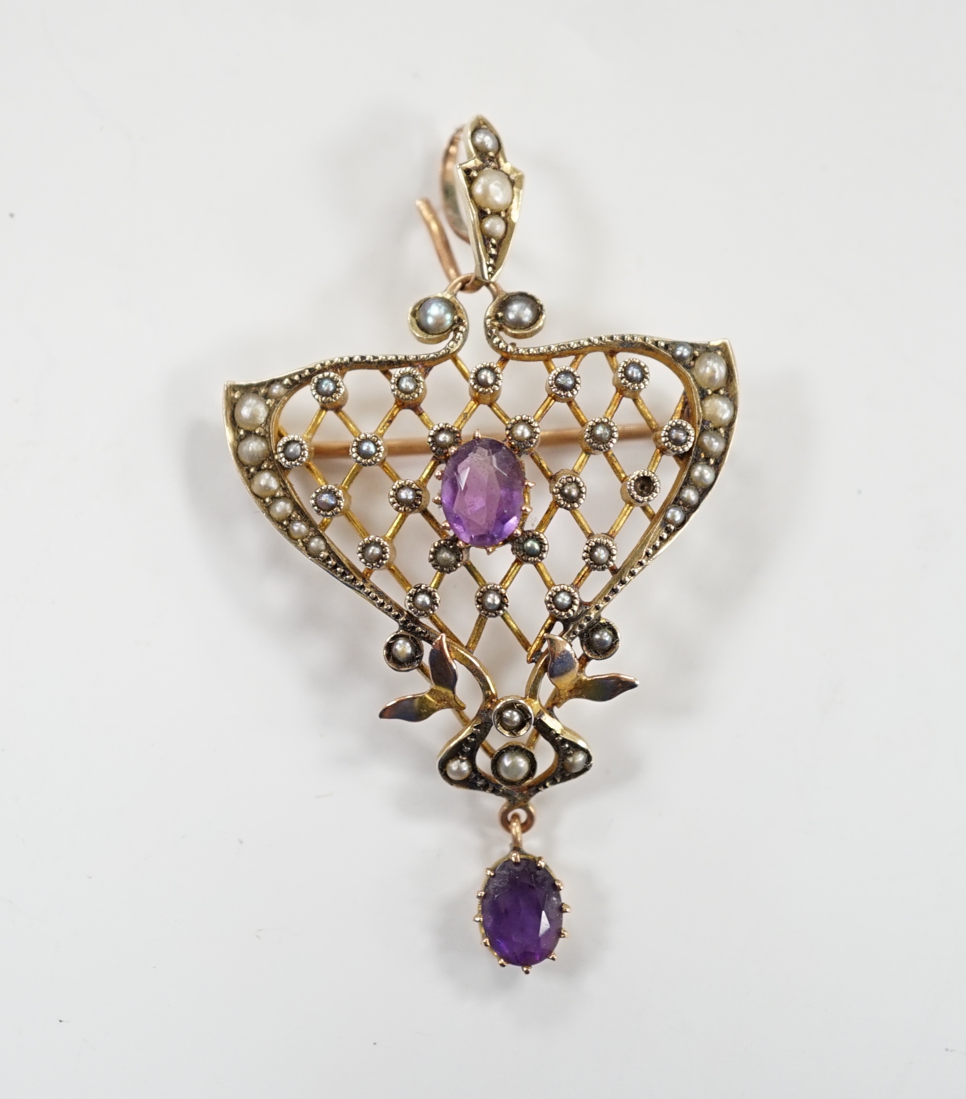 An Edwardian Art Nouveau 9ct, amethyst and seed pearl set drop pendant, 50mm, gross weight 5.2 grams.